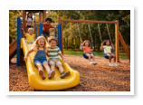 Kids playing on our playground here at Oak and Loon Campground.